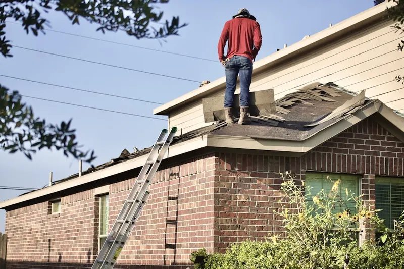 Professional roofer working on a residential roof in Aikin